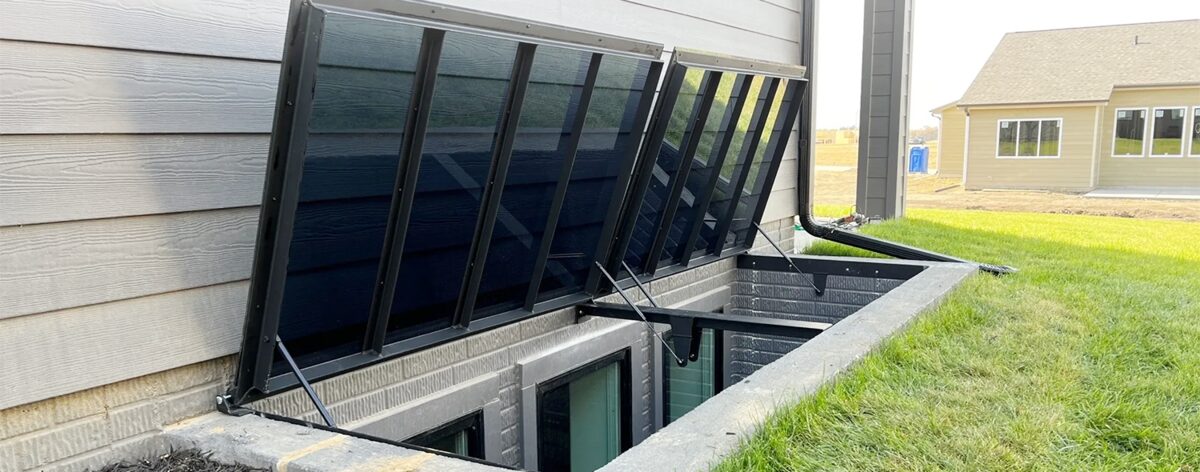 Heavy-duty gas struts holding open outdoor basement doors